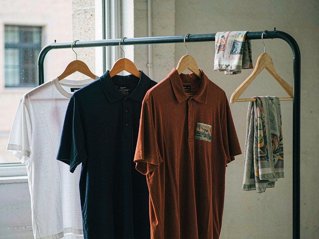 Custom printed polyester garments on a clothing rail in a print studio
