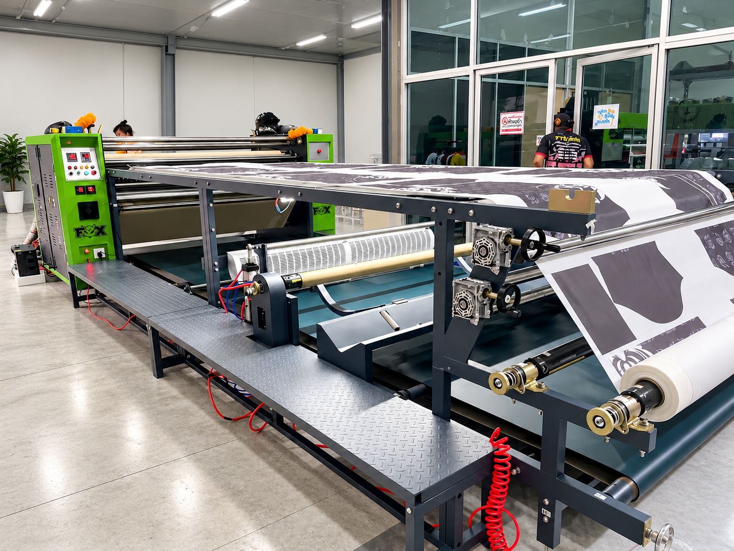 A roller heat transfer machine with chrome rollers and two feed rolls of transfer material mounted in front of the drum