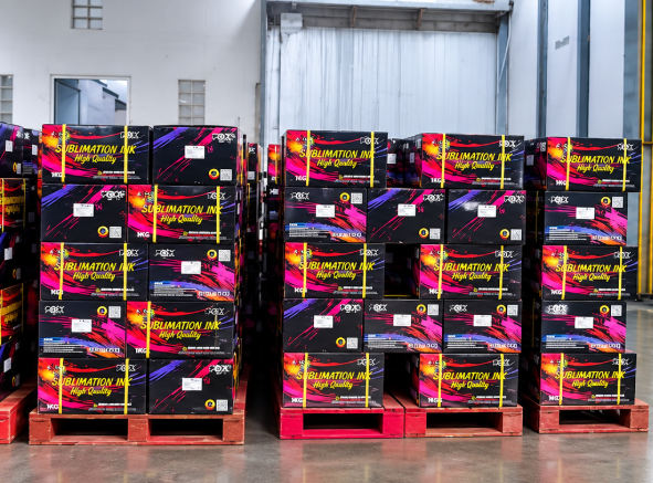 Pallets of boxed sublimation ink stacked in a warehouse