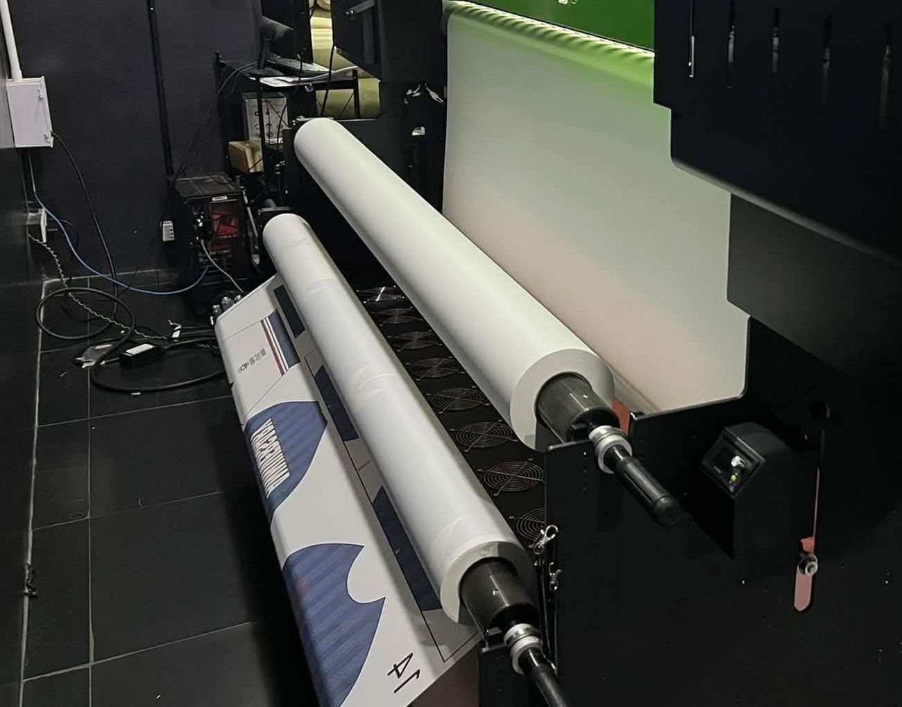 Digital printer producing a printed roll of sublimation transfer paper in production